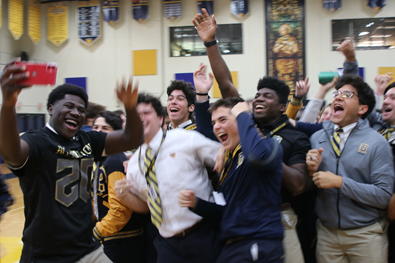 Belen Jesuit Don Chaney Jr. takes a selfie with his varsity football teammates during the pep rally where he received his All-American Bowl football jersey - the first player in Belen history to be selected.