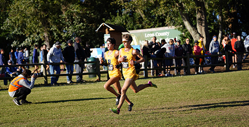 Belen Jesuit's Diego Gomez (#48) and Adam Magoulas (#50) run side by side to finish third and fourth, respectively, to help their school win its record-breaking 11th state cross country championship.