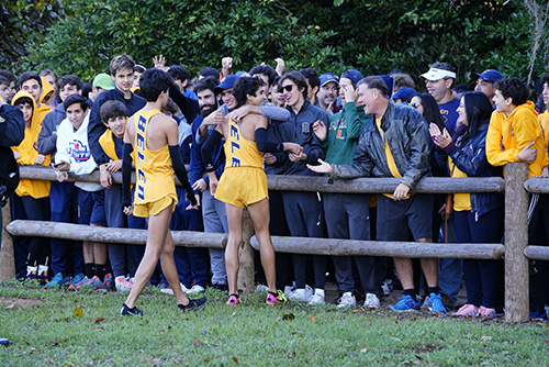 Belen Jesuit runners gets hugs and high-fives from their parents and school supporters after finishing the 5K race for the state cross country championship.