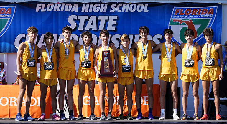 Belen Jesuit's cross country runners pose with their trophy and medals after winning the school's record-breaking 11th cross country state championship, Nov. 9, 2019, in Tallahassee.