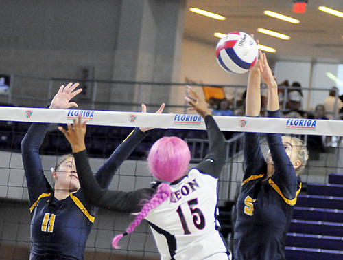 St. Thomas Aquinas' Meredith Dixon (5) blocks Leon's A'niyah Cobb as STA's Kalin Hubbard, left, joins in during St. Thomas Aquinas' Class 6A girls volleyball state final vs. Tallahassee Leon, Nov. 15, 2019 at Suncoast Credit Union Arena in Fort Myers. Leon won the match 18-25, 25-10, 25-22, 26-24 for its second title.