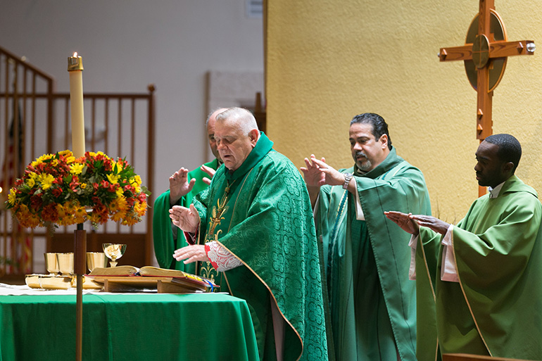 Archbishop Thomas Wenski celebrates the Mass marking the 60th anniversary of St. Elizabeth of Hungary parish, Pompano Beach, Nov. 17, 2019. Behind him, from left, are Father Harry Loubriel, pastor, and Father Fenly Saint-Jean, parochial vicar.