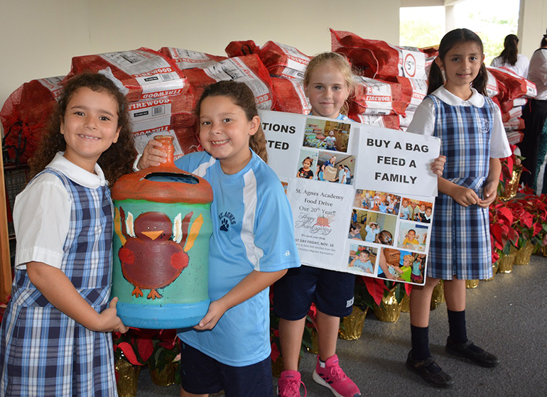 From left, St. Agnes Academy students Stella Roubach-Tomeo, Katerina Papadopoulos, Ana Viel Temperley, and Estefania Bejarano collected donations for the Thanksgiving Food Drive.
Pictured in photo 5: Second grade students helped fill the bags with Thanksgiving food items.