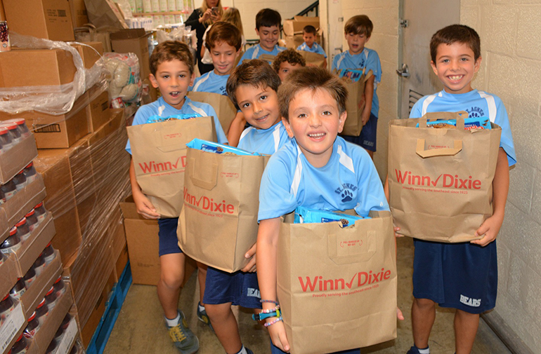 Second grade students at St. Agnes Academy helped fill the bags with Thanksgiving food items.