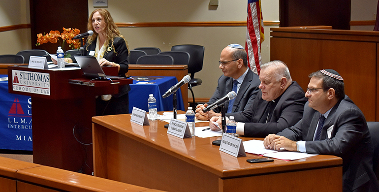 Law professor Rosa Pati puts questions to a panel of experts during a discussion on Vatican-Israel relations at St. Thomas University. The event honored the 25th anniversary of the Holy See's recognition of the Jewish state.