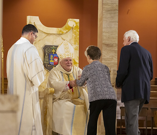 Archbishop Thomas Wenski receives the offertory from Jim and Lourdes Cowgill of St. Sebastian Parish in Fort Lauderdale. The couple received the One in Hope award during the Thanks-for-Giving Mass celebrated at the Cathedral of St. Mary, Nov. 23, 2019.