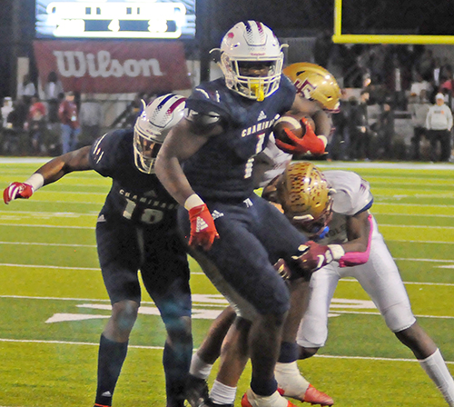 Chaminade-Madonna running back Thaddius Franklin (1) pulls for extra yards on the 10-yard run that clinched the state-finals record for rushing yards in Chaminade-Madonna's 35-20 victory over Tallahassee Florida High Friday, Dec. 6, 2019, in the 2019 FHSAA 3A state football championship game at Gene Cox Stadium in Tallahassee. Franklin ran for a state-finals-record 333 yards on 47 carries with five touchdowns as the Lions won their third consecutive state title and fifth overall.