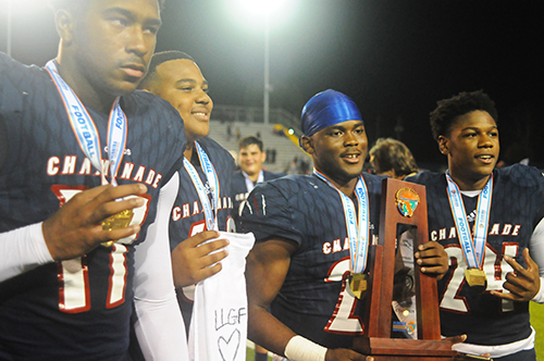 Players (from left) Claude Larkins, Kalun Matthew, Derek Geffrard and Charles Williams celebrate with the trophy after Chaminade-Madonna's 35-20 victory over Tallahassee Florida High Friday, Dec. 6, 2019, in the 2019 FHSAA 3A state football championship game at Gene Cox Stadium in Tallahassee. The Lions won their third consecutive state title and fifth overall.