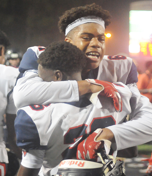 Columbus players Trynyty Conway and Jahvar McSween celebrate Christopher Columbus Catholic's 21-20 victory over Apopka in the Class 8A state football championship game at Daytona Stadium. The Explorers won their first state title after going 0-5 in previous finals.