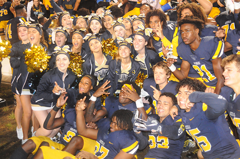 St. Thomas Aquinas players and cheerleaders celebrate the Raiders' 28-23 victory over Orlando Edgewater on Dec. 14, 2019, in the Class 7A FHSAA state football championships at Daytona Stadium in Daytona Beach.