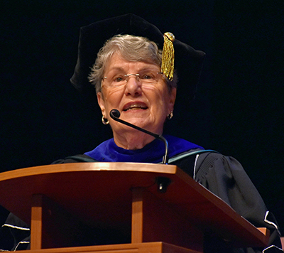 Sister Linda Bevilacqua, past president of Barry University, presents the symbolic chain of leadership to Mike Allen during his inauguration as the next president.