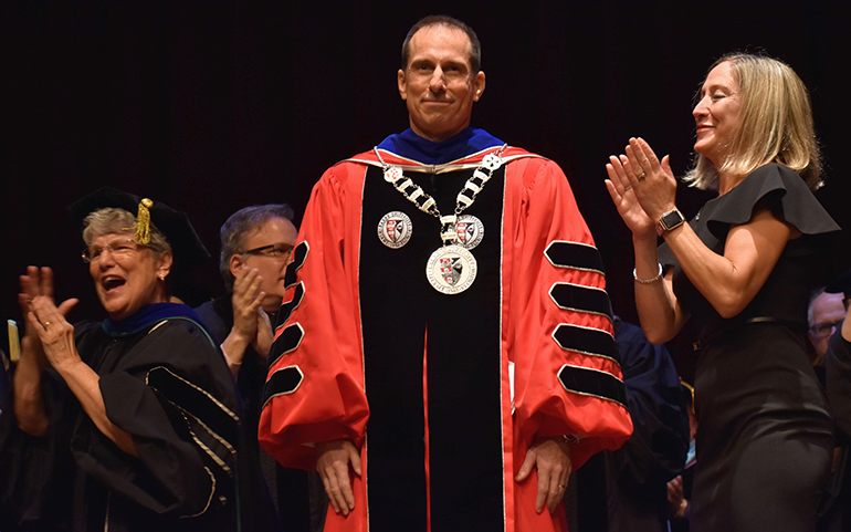 Mike Allen accepts applause after his inauguration as president of Barry University. With him on stage, from left, are Sister Linda Bevilacqua, past president of Barry, and his wife, Beth.