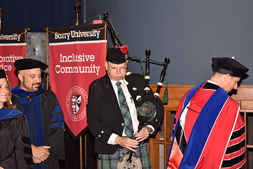 Charles Southerland, a professor of podiatric medicine, supplies traditional bagpipe music for the inauguration of Mike Allen as president of Barry University.