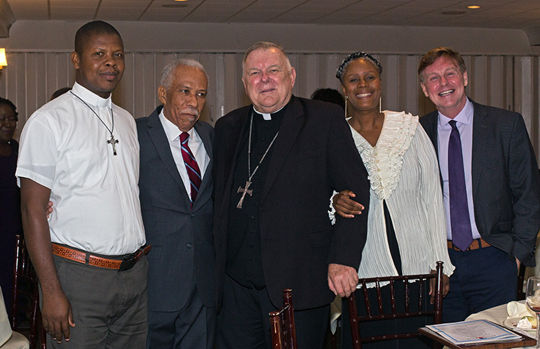 Posing for a photo after Haiti First's seventh annual Fundraising Cultural Night, held Nov. 16, 2019 in Miami Shores, are, from left: Father Franckel Fenelus, pastor of St. Joseph Parish in Lozier, Haiti; Justin Manuel, Haiti First founder; Archbishop Thomas Wenski; Myriam Mezadieu and Randolph McGrorty of Catholic Legal Services.
