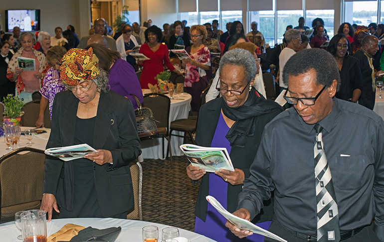 From right, Jimmy Knowles, Bonita Smith and Margie Frances sing the Black National Anthem, "Lift Every Voice and Sing," at the close of the annual Black Catholic History Month awards luncheon, held at the Stadium Hotel in Miami Gardens, Nov. 16 2019.