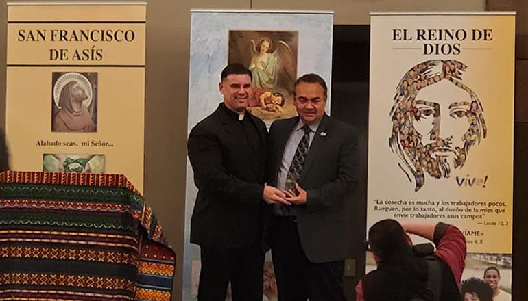 Father Rafael Capó receives his Hispanic Heritage Partner Award for 2019 from Roberto Navarro, senior director of U.S. Church Engagement for Catholic Relief Services.
