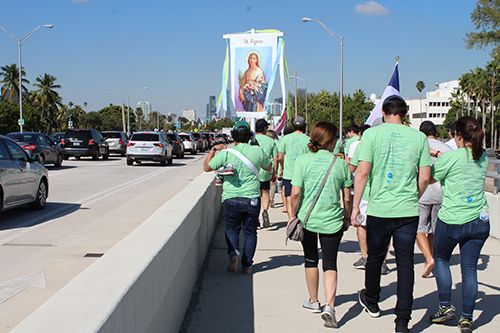 Pilgrims from St. Agnes Church make their way to the end of Bear Cut Bridge as they journey towards the Shrine of Our Lady of Charity Dec. 7, 2019.
