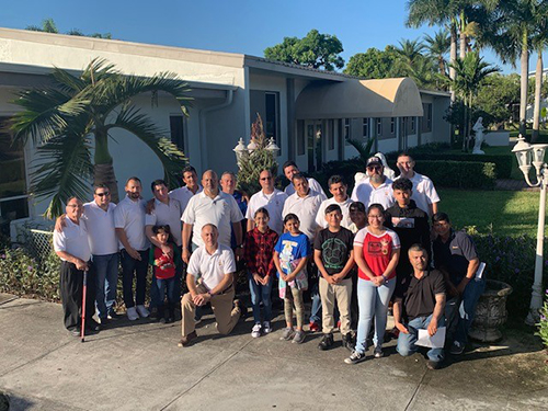 Members of Emmaus at Immaculate Conception Church in Hialeah pose for a photo before delivering 21 Christmas trees to needy families Dec. 14, 2019.