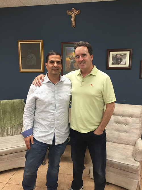 Dr. Shawn Fibkins, right, poses with his friend and life-saver, John Fernandez, after reflecting on the journey that brought them together at an Emmaus retreat at St. John Neumann Church in Miami. Fernandez is director of religious education at St. John Neumann. Fibkins is a radiologist now living in Parkland, where he is a member of Mary, Help of Christians parish.
