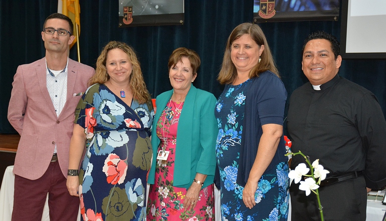 Leaders gather for the announcement of St. Hugh School winning certification as a STREAM school. From left are Robert Wright of Key West, who served on the accreditation committee; Marcey Ayers, director of special programs for the archdiocese; Mary E. Fernandez, principal at St. Hugh; Mary Camp, associate director for accreditation with the Florida Catholic Conference; and Father Luis Largaespada, pastor at St. Hugh Church.