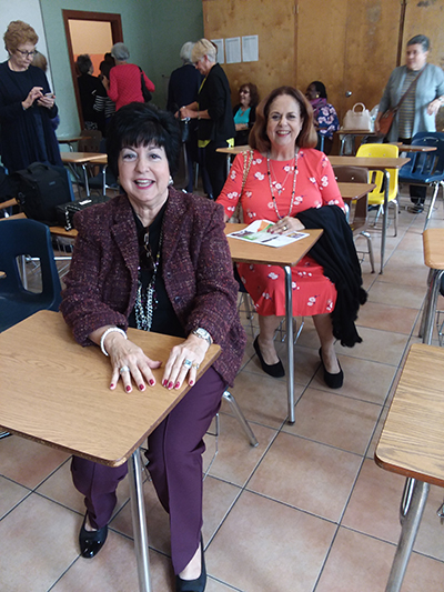 Elsa Reus, front, and former classmate Vivian Toscano sit one behind the other, as they did in Mrs. Hermo's French class 50 years ago. The alums made a return trip to Notre Dame Academy - now the Pierre Toussaint Haitian Center - Nov. 17, 2019.