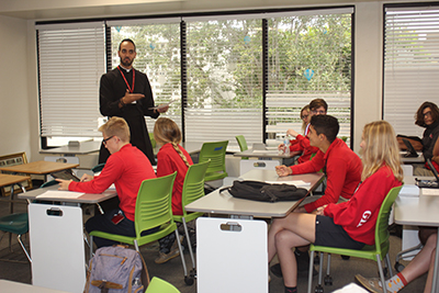 Piarist Father Ricardo Rivera connects with senior students in the classroom during theology lessons at Cardinal Gibbons High in Fort Lauderdale.