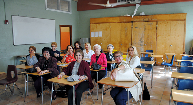 Elsa Reus, second from left, in front, and fellow Notre Dame Academy class of 1969 alumnae, sit in their old French classroom, which they found unchanged when they returned after 50 years to what is now Notre Dame d'Haiti Mission and Pierre Toussaint Haitian Catholic Center.