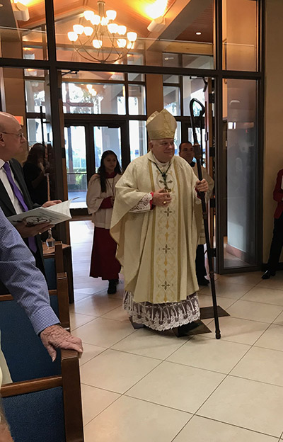 Archbishop Thomas Wenski processes into St. Henry Church for the Mass concluding the parish's year-long celebration of its 50th anniversary, Jan. 11, 2020.