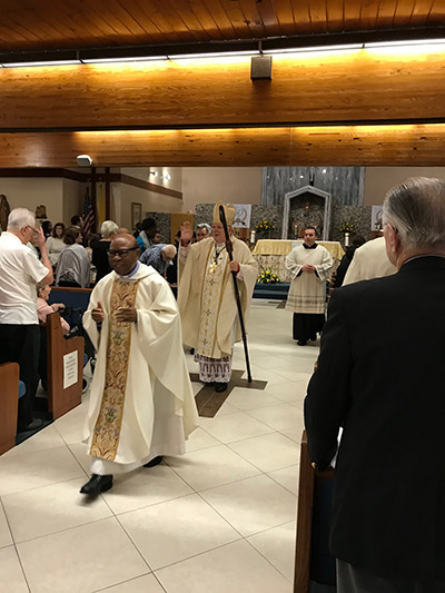 Archbishop Thomas Wenski exits St. Henry Church after the Mass marking the conclusion of the parish's year-long celebration of its 50th anniversary, Jan. 11, 2020. Walking in front is St. Henry's pastor, Spiritan Father Francis Akwue.