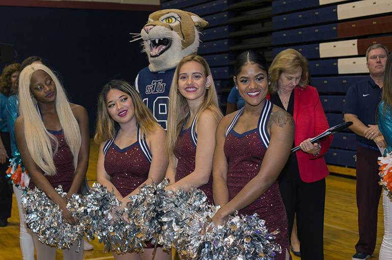 St. Thomas University cheerleaders and mascot pose for the camera at the NFL Super Kids-Super Sharing Super Bowl community impact project, Jan. 16, 2020 at St. Thomas University. The project puts lightly used sports equipment and school supplies into the hands of schools in need.