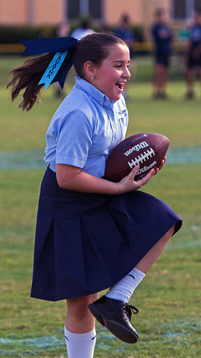 St. Agatha fourth-grader Natalia Quesada catches a football during the play session with Dolphins and St. Thomas University sports staff which took place during the NFL Super Kids-Super Sharing event, a Super Bowl-related community impact project which took place Jan. 16, 2020 at St. Thomas University. The project puts lightly used sports equipment and school supplies into the hands of schools in need.