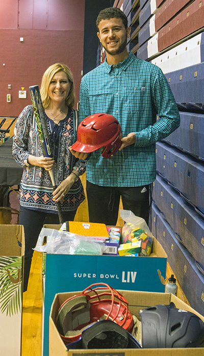 Stephanie Murphy, St. Jerome School principal,and Rafael Villalobos, athletic director, pose with some of the donated sports equipment they will take back to St. Jerome School after the NFL Super Kids-Super Sharing event, a Super Bowl-related community impact project which took place Jan. 16, 2020 at St. Thomas University. The project puts lightly used sports equipment and school supplies into the hands of schools in need.