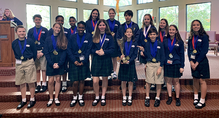 Mary Help of Christians sixth, seventh and eighth graders pose with the hardware they won at the South Regional Science Olympiad competition, held Jan. 18, 2020, at the University of Miami. Their first place finish earned them the right to compete at the state finals set for March 21 at the University of Florida in Gainesville.
