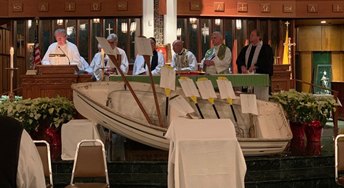 Religious leaders take turns leading prayers as a boat, symbol for the evening, adorns the sanctuary during the ecumenical service hosted by St. Paul the Apostle Church in Lighthouse Point, Jan. 23, 2020.