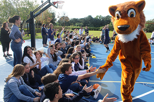 Here comes the Lion: St. Mark School's mascot hands out high-fives during the first pep rally in the school's history on Jan. 24, 2020. The celebration coincided with the school's 25th anniversary, and also kicked off Catholic Schools Week.