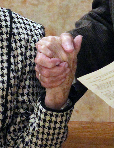 Couples hold hands as they renew their marriage vows at the wedding anniversary Mass celebrated at St. Mary Cathedral Jan. 25, 2020.