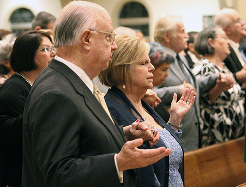 John and Beatriz Harriman hold hands during the Lord's Prayer at the wedding anniversary Mass celebrated at St. Mary Cathedral Jan. 25, 2020. The Harrimans are the founding couple of Matrimonios en Victoria (Marriages in Victory), a marriage movement in the Archdiocese of Miami, and were celebrating their 50th anniversary.