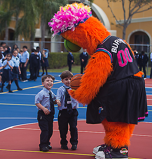 Heat mascot Burnie entertains Jonathan Hecht, 3, and his brother, Sebastian Hecht, 5, after the blessing of Mother of Our Redeemer School's new basketball-volleyball court, Jan. 27, 2020.