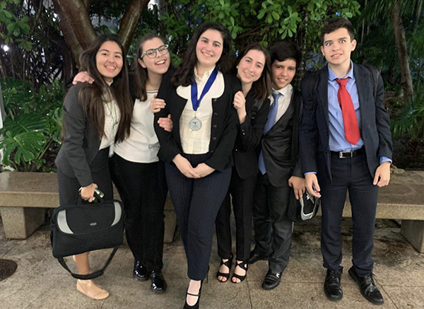 Immaculata-La Salle senior Isabella Perez, pictured here with fellow debate team members, is headed to the state competition after earning second place at the district debate tournament Feb. 2, 2020.