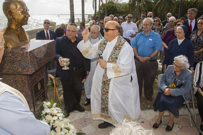 Father Fernando E. Hería, rector of the National Shrine of Our Lady of Charity, blesses with holy water the newly unveiled bust of the venerable Brother Victorino de la Salle.