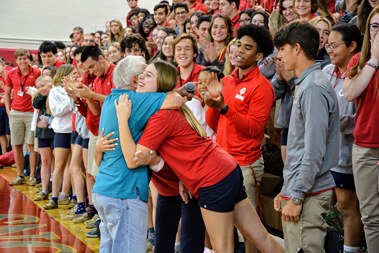 Holocaust survivor Bernard Igielski hugs a Cardinal Gibbons student after his talk to juniors and seniors at the school Feb. 20, 2020.