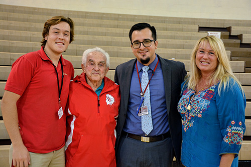 Cardinal Gibbons senior Michael Field poses with his neighbor, Holocaust survivor Bernard Igielski, along with Gibbons principal Oscar Cedeño and Yelena Ilyina, Michael's mother.