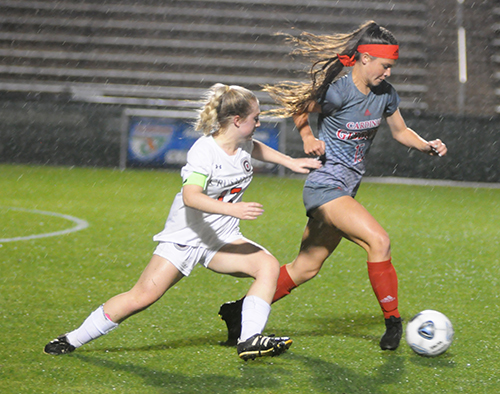 Cardinal Gibbons forward Ashley Nouss tries to break away from Bishop Kenny midfielder Gabi Iuliano during the first half of their FHSAA Class 4A girls soccer state-championship match, Feb. 26, 2020 at Spec Martin Stadium in DeLand. Bishop Kenny won the match 2-1.