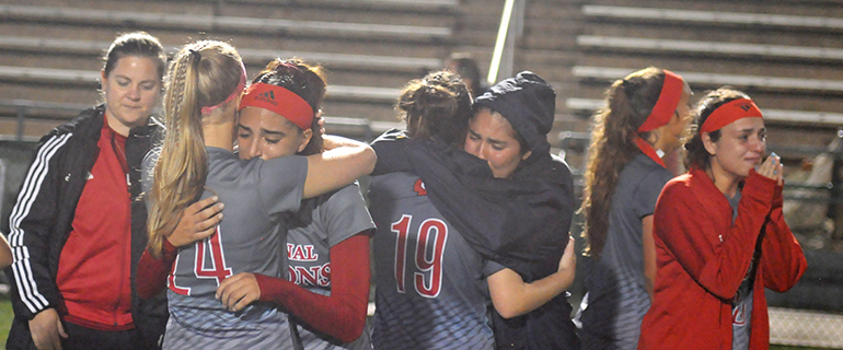 Cardinal Gibbons girls soccer players share in their sadness after falling to Bishop Kenny 2-1, Feb. 26, 2020 in the FHSAA Class 4A girls soccer state championship match at Spec Martin Stadium in DeLand.