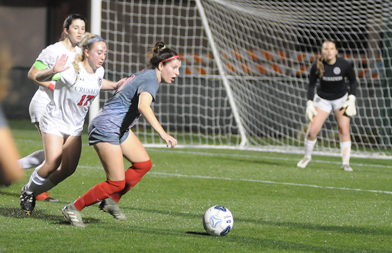 Cardinal Gibbons midfielder Gianna Mitchell, right, looks for an open player while moving away from Bishop Kenny's Gabi Iuliano during the first half of the Feb. 26, 2020 FHSAA Class 4A girls soccer state-championship match at Spec Martin Stadium in DeLand.