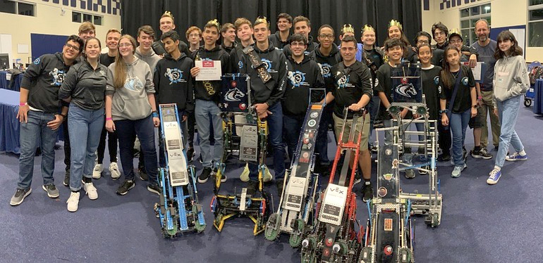 Members of McCarthy High School's team Maverick Robotics show off their machines and awards after winning the state championship Feb. 29 at Florida International University.