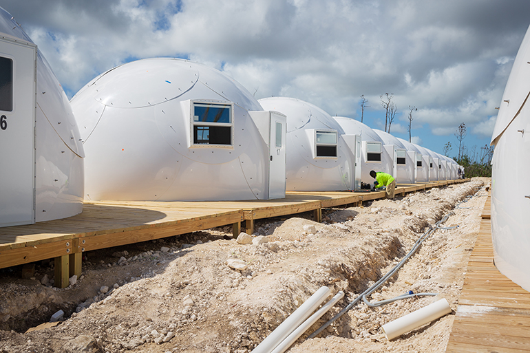 A dome structure village of temporary shelters is under construction in Abaco following last year's Hurricane Dorian.