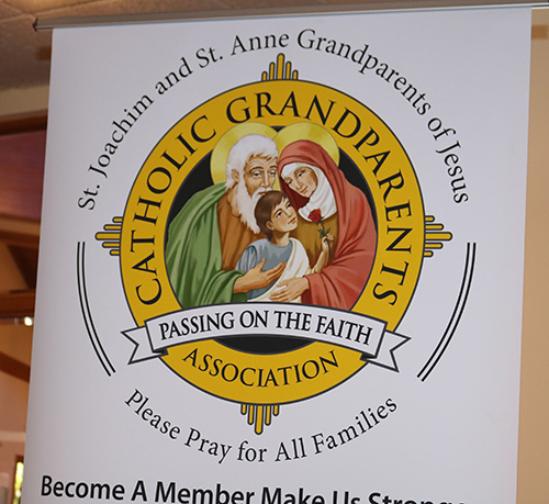 A poster featuring the Holy Family is part of the displays at a meeting held Feb. 20, 2020 at Assumption Parish in Lauderdale-By-The-Sea. The meeting was designed to inform participants about a new ministry aimed at helping and supporting grandparents in archdiocesan parishes.