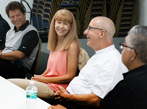 In this file photo from November 2019, Patrice Schwermer, the Key West-based Catholic Charities program director for Monroe County, sits with Father Luis Alberto Perez, right, pastor of San Pablo Catholic Church, and with Peter Routsis-Arroyo, CEO of Catholic Charities of the Archdiocese of Miami. Members of Catholic Charities' board of directors were touring parishes and programs in Monroe County. Local agencies are worried about the effects of the COVID-19 pandemic on local homeless populations.