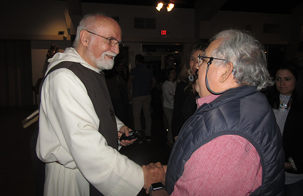 Father Jacques Philippe greets one of the faithful who attended his talk at St. Augustine Church in Coral Gables, March 6, 2020.